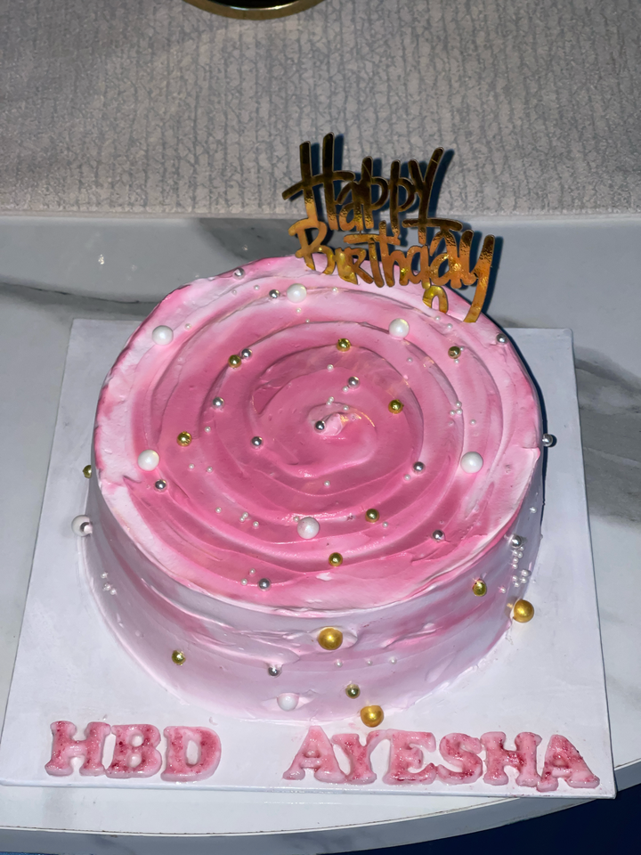 Pink birthday cake with gold Happy Birthday topper - Delice Bakes Lahore